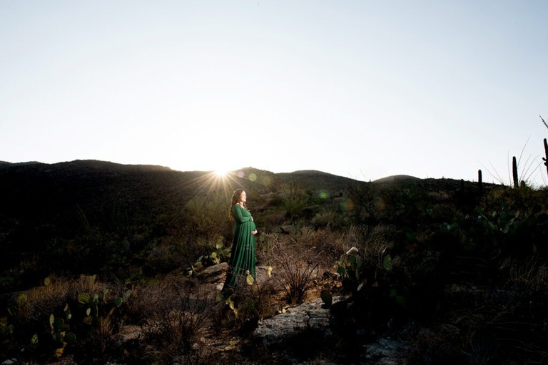 pregnant-woman-in-a-green-dress-at-sunrise-in-the-desert