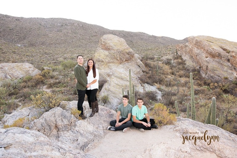 family on a rock in the middle of the tucson desert