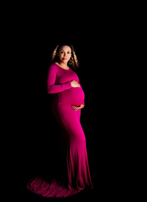 Tucson-Studio-Maternity-photo-woman-wearing-pink-dress-standing-up