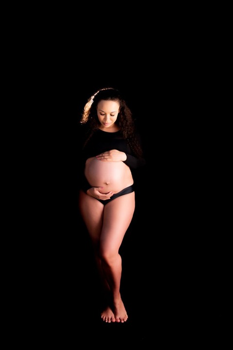 Tucson-Studio-Maternity-photo-woman-wearing-black-belly-exposed-standing-up