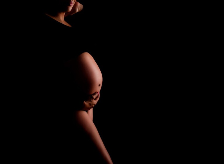 Tucson-Studio-Maternity-photo-woman-wearing-black-belly-exposed-close-up