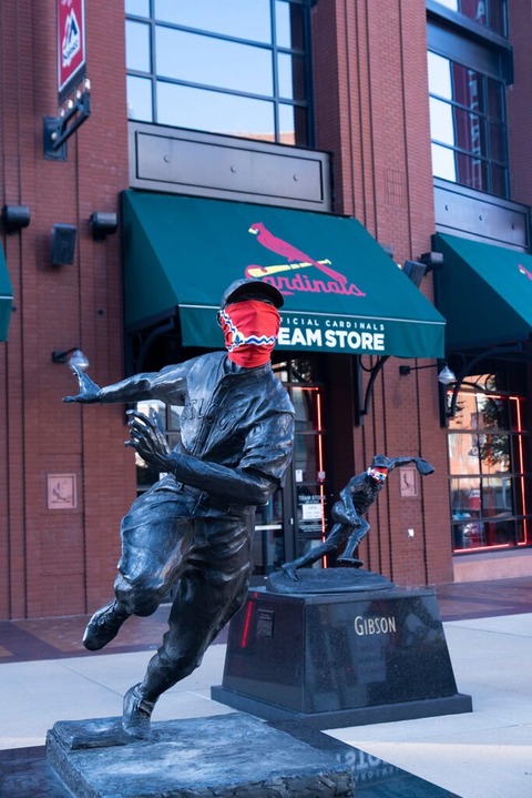 statue of a cardinals baseball player wearing a red mask