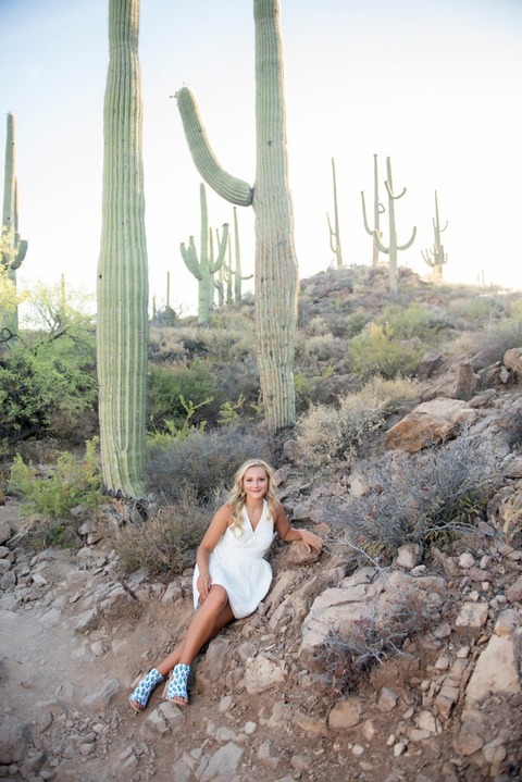 senior pictures in the desert wearing a white dress