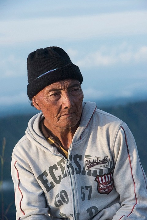 local Indonesian man at the top of Mt. Batur in Bali Indonesia