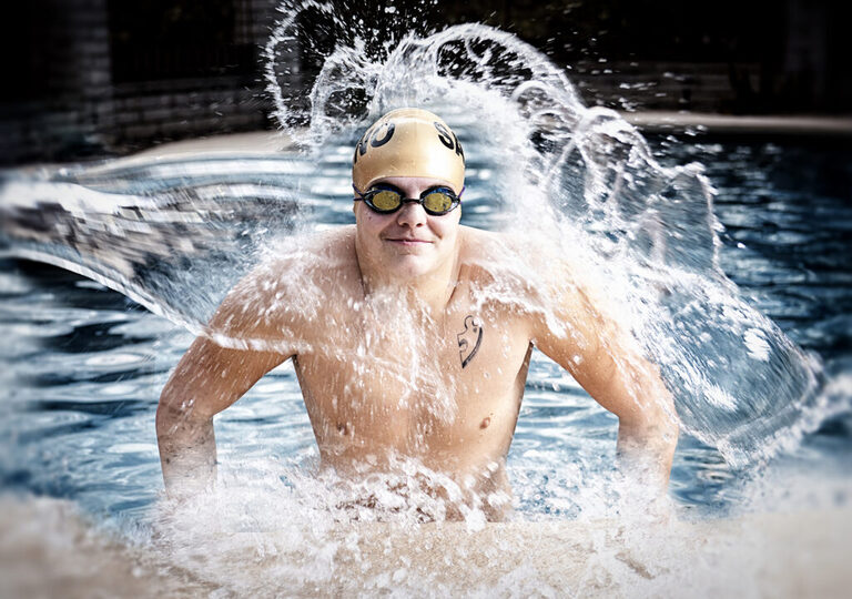 photo of a swimmer coming out of the water wearing a swimming cap and goggles for his tucson senior pictures for guys