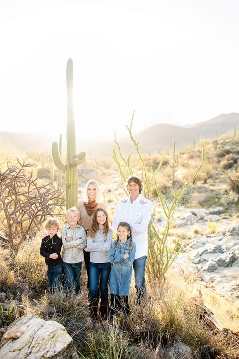 morning at tanque verde ranch tucson family photo session family standing in desert near a saguaro cactus