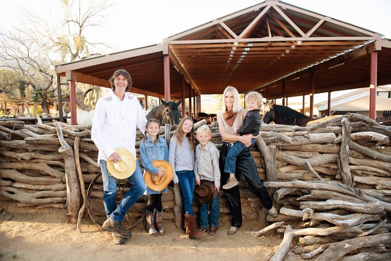 morning at tanque verde ranch tucson family photo session family standing by horse corral