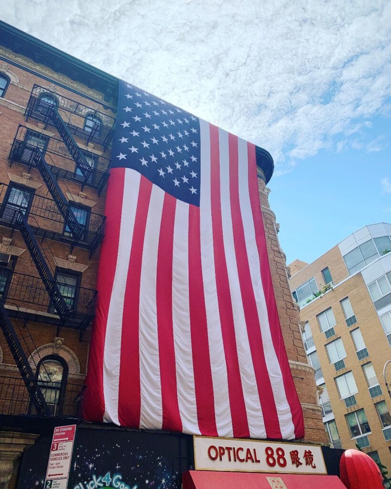 flag draped building in lower east side new york china town