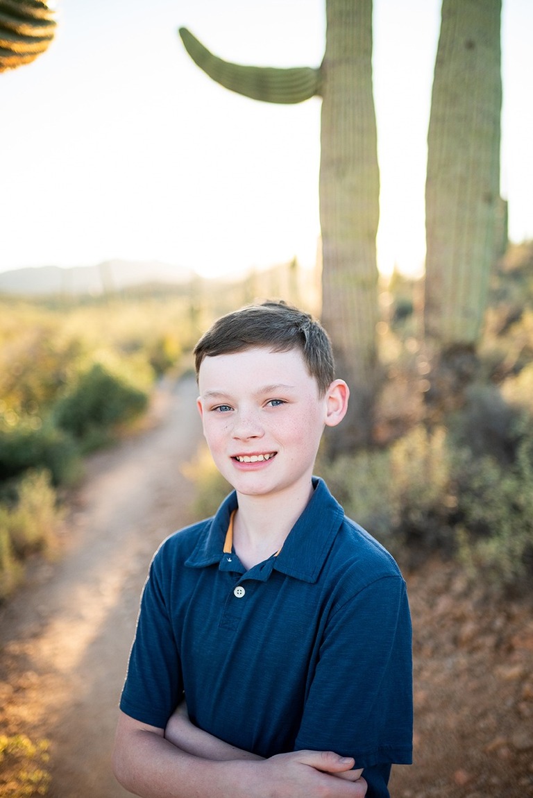 boy wearing blue with saguaro cactus