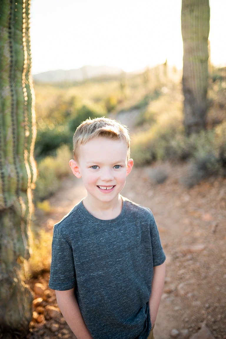 boy smiling with saguaro cactus