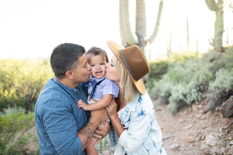couple kissing toddler